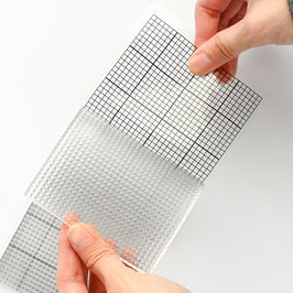 Altenew The Original Mini Sticky Mat 9x3.5 inches with classic grid pattern, used for crafting and tool organization.