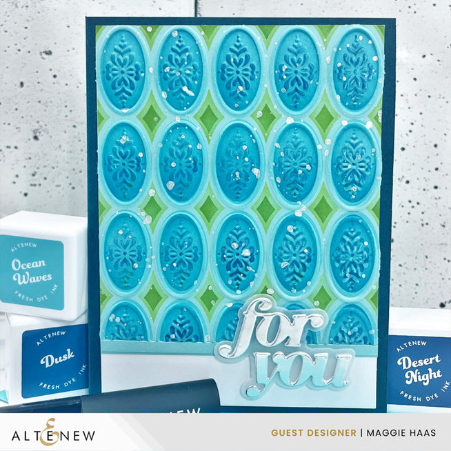 Altenew Heirloom Filigree stencil and embossing folder with intricate floral designs on warm-colored paper.