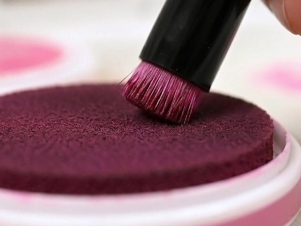 Tap or swirl the brush onto the ink pad to pick up color.